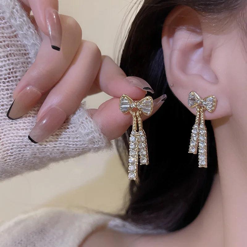 WOLZI Elodie Crystal Bow Stud Earrings in gold tone