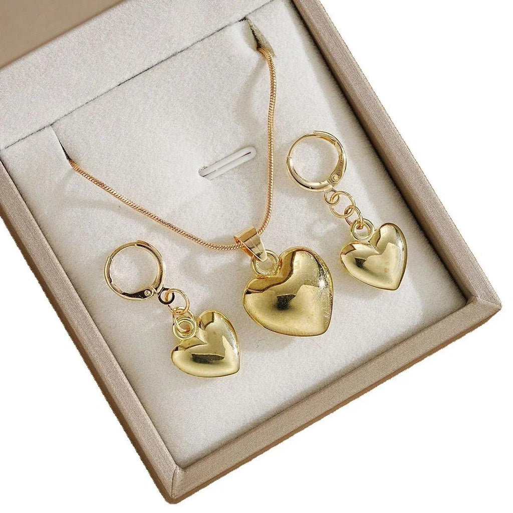 WOLZI Amoura rose gold heart jewelry set featuring a necklace and earrings in a gift box