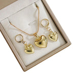 WOLZI Amoura rose gold heart jewelry set featuring a necklace and earrings in a gift box
