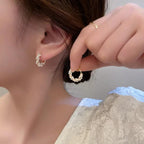 WOLZI Lumi Pearl Circle Stud Earrings in gold with shimmering pearl accents.