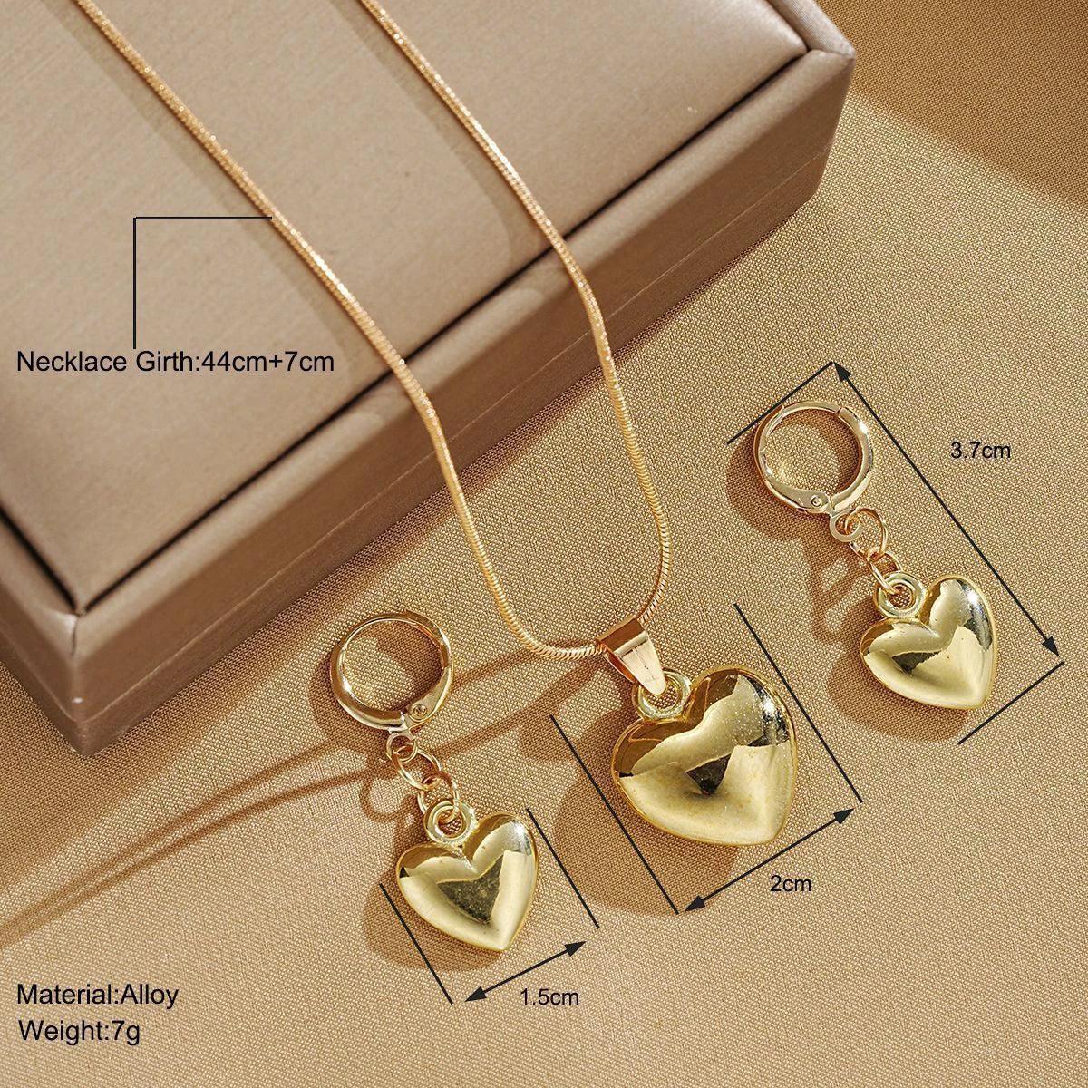 WOLZI Amoura rose gold heart jewelry set including a necklace and matching earrings.
