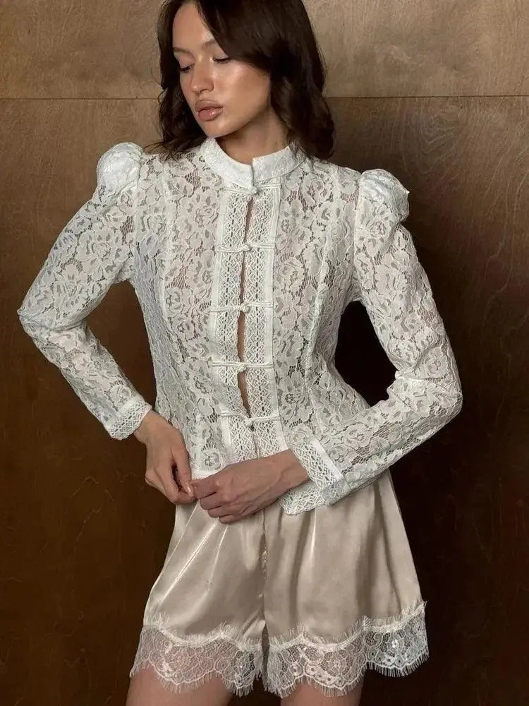 Model wearing WOLZI Fontaine white lace blouse with puff sleeves and satin shorts.