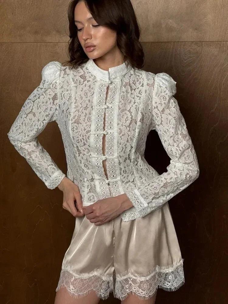 Model wearing WOLZI Fontaine white lace blouse with puff sleeves and satin shorts.