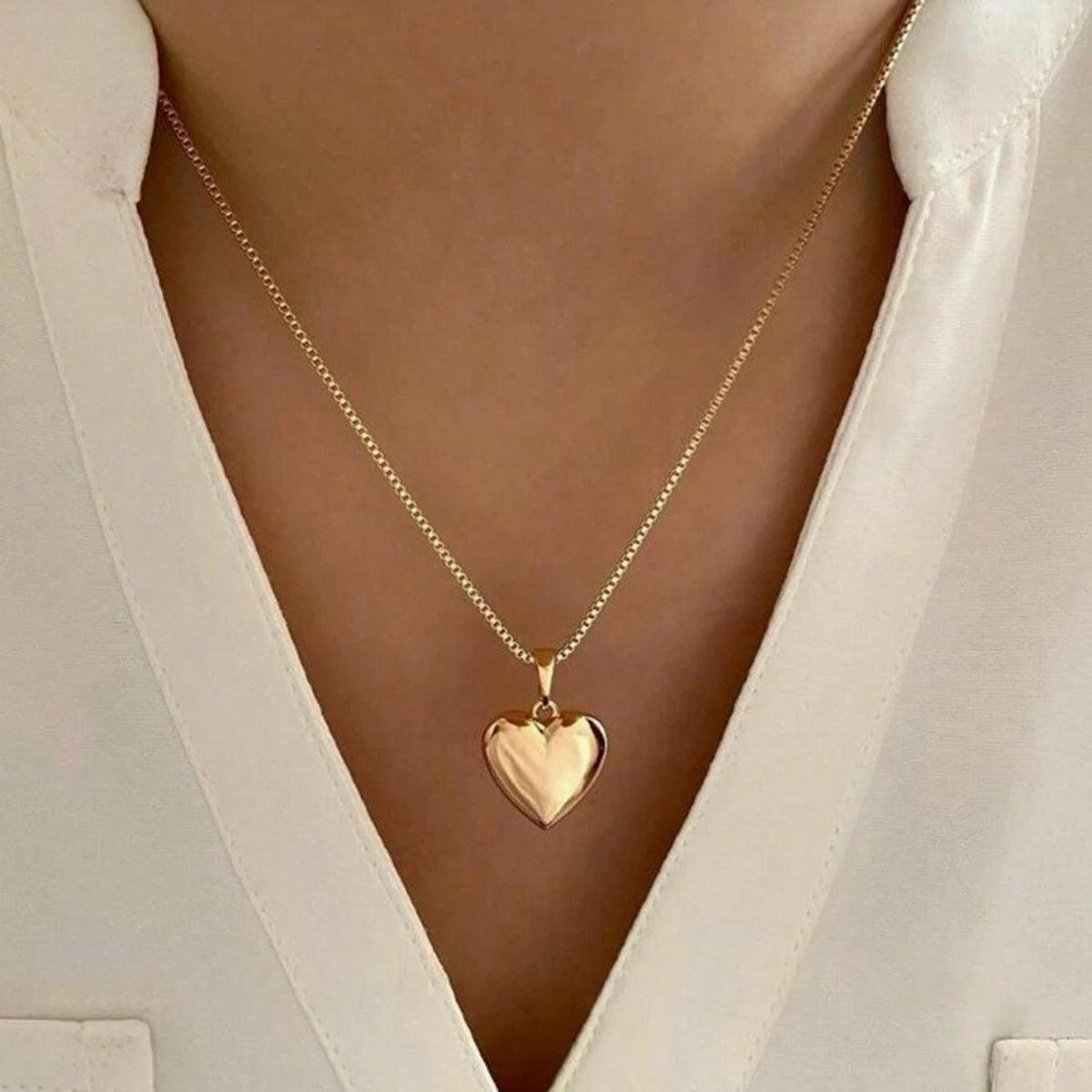 WOLZI Amoura Rose Gold Heart Pendant Necklace on a woman wearing a white blouse