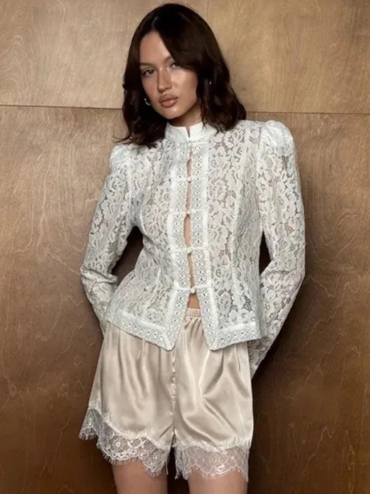 Woman wearing a white WOLZI Fontaine Lace Blouse with satin lace-trim shorts.