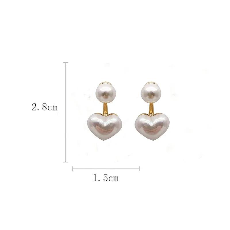 Amelie heart pearl earrings by WOLZI, measuring 2.8cm by 1.5cm.