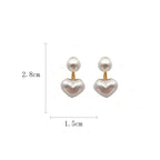 Amelie heart pearl earrings by WOLZI, measuring 2.8cm by 1.5cm.