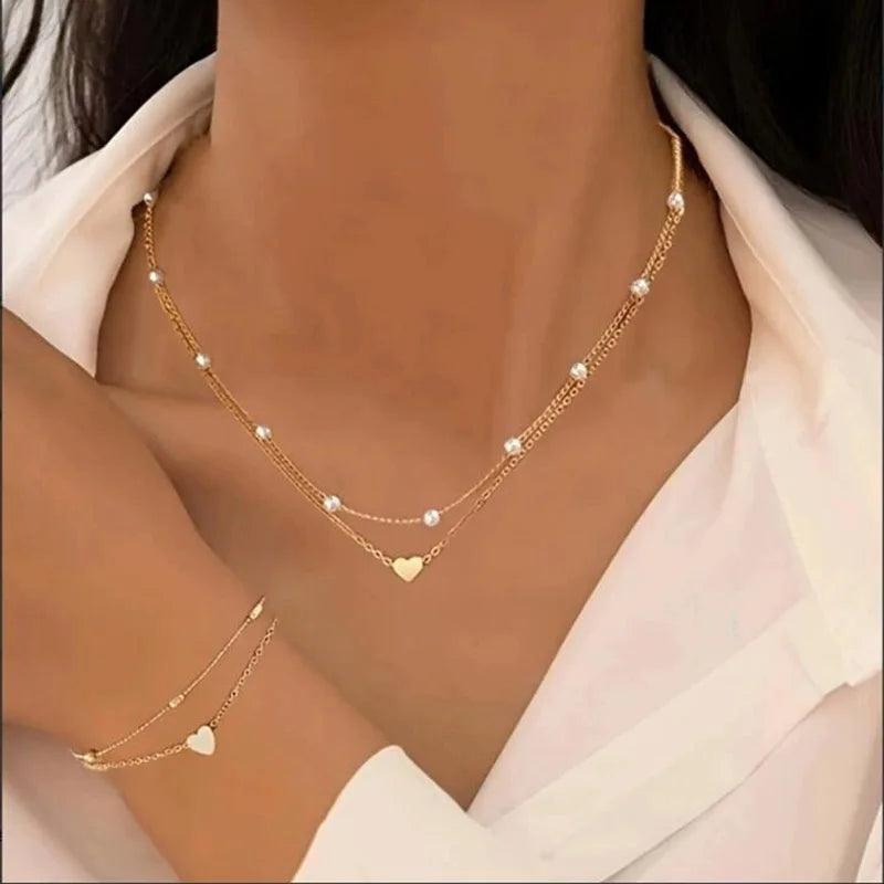 WOLZI Amorette Pearl Heart Jewelry Set featuring a gold layered necklace and matching bracelet
