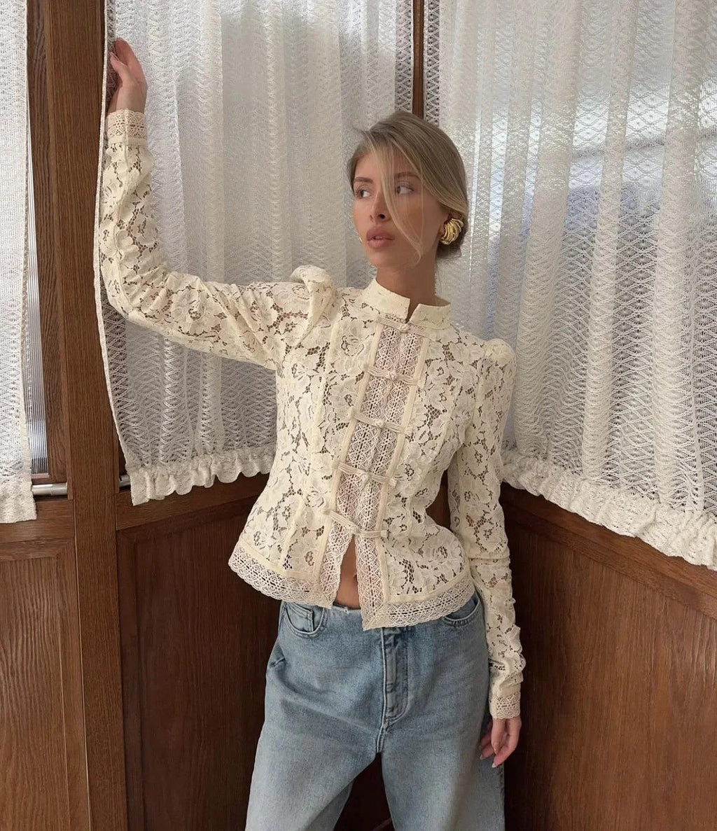 Woman wearing WOLZI Fontaine Lace Blouse in beige with long sleeves and floral patterns.