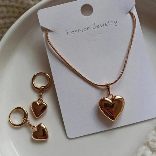 WOLZI Amoura rose gold heart jewelry set featuring a necklace and matching hoop earrings.