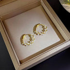WOLZI Lumi Pearl Circle Stud Earrings in a gold hoop design with delicate white pearls.