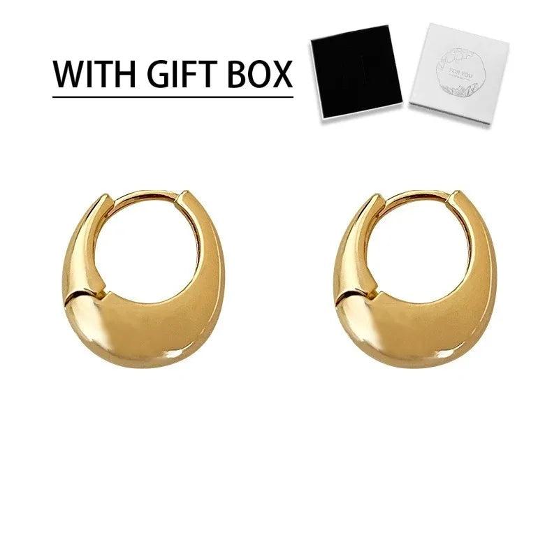 WOLZI Aurelle Sculpted Oval Gold Hoop Earrings with a gift box.