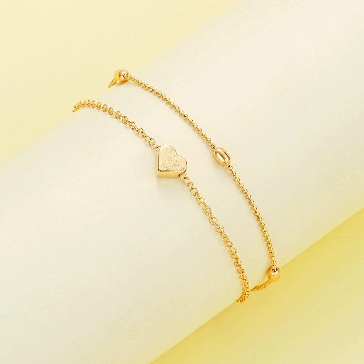 WOLZI Amorette gold-toned chain bracelet set with a heart charm and pearl accents