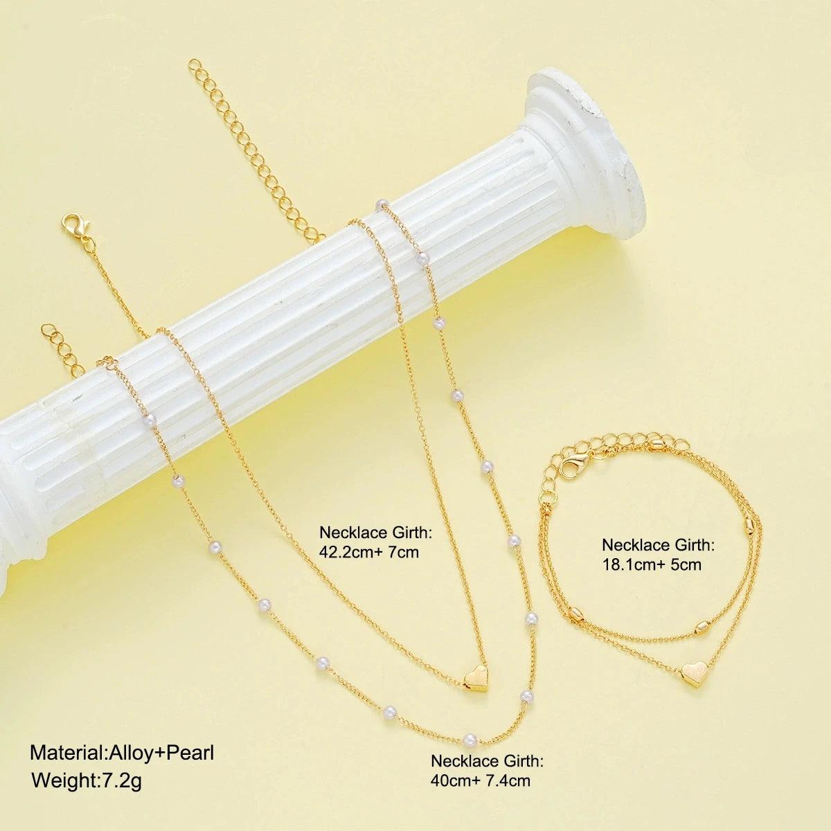 WOLZI Amorette Pearl Heart Jewelry Set with gold-tone necklaces and matching bracelet.