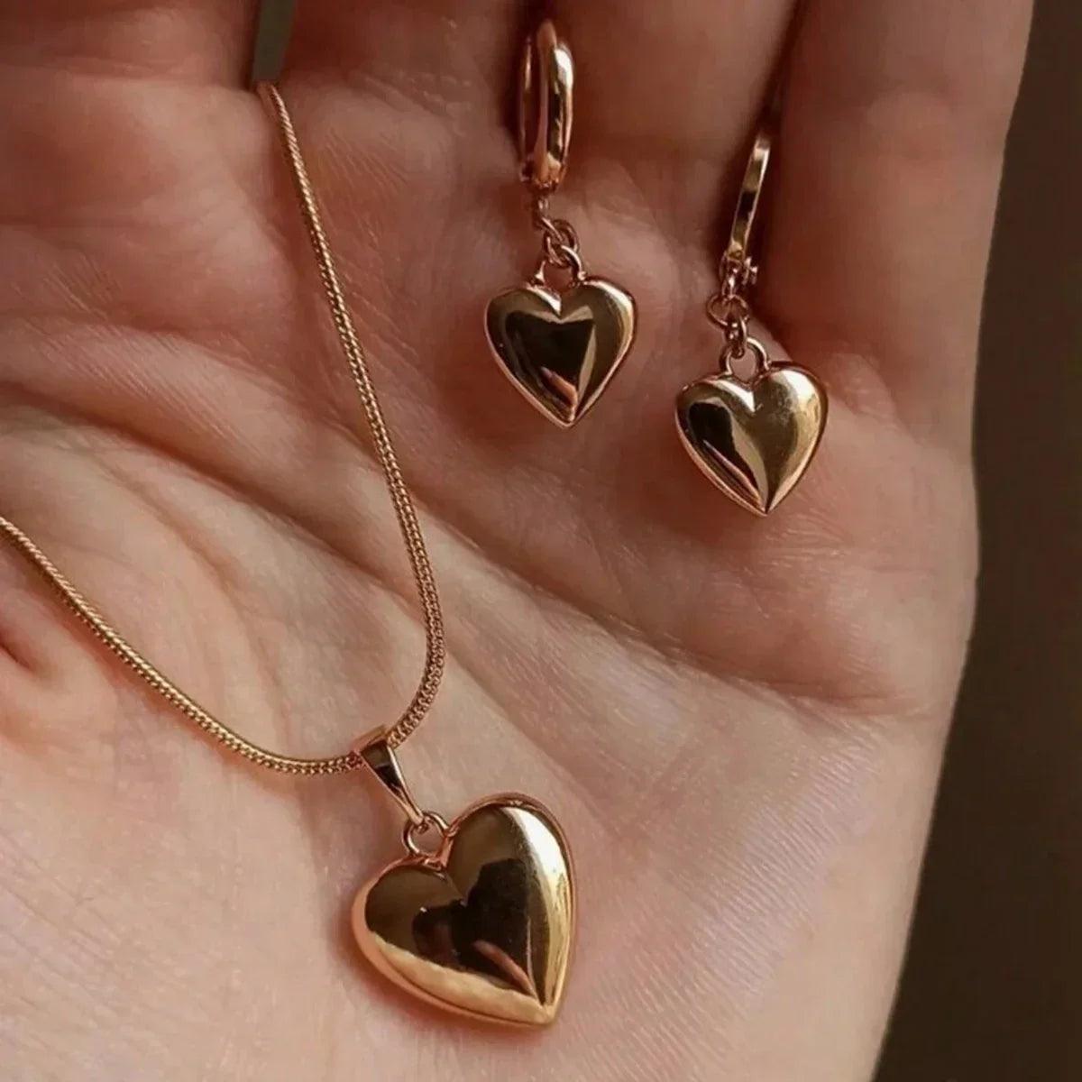 WOLZI Amoura Rose Gold Heart Jewelry Set featuring a heart pendant necklace and matching earrings