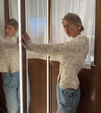 Woman wearing a WOLZI Fontaine Lace Blouse in beige paired with light blue jeans.